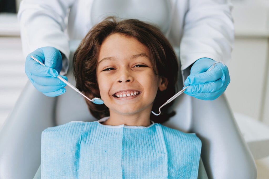 Child smiling during a dental appointment at a family dental office in Lemont, IL.